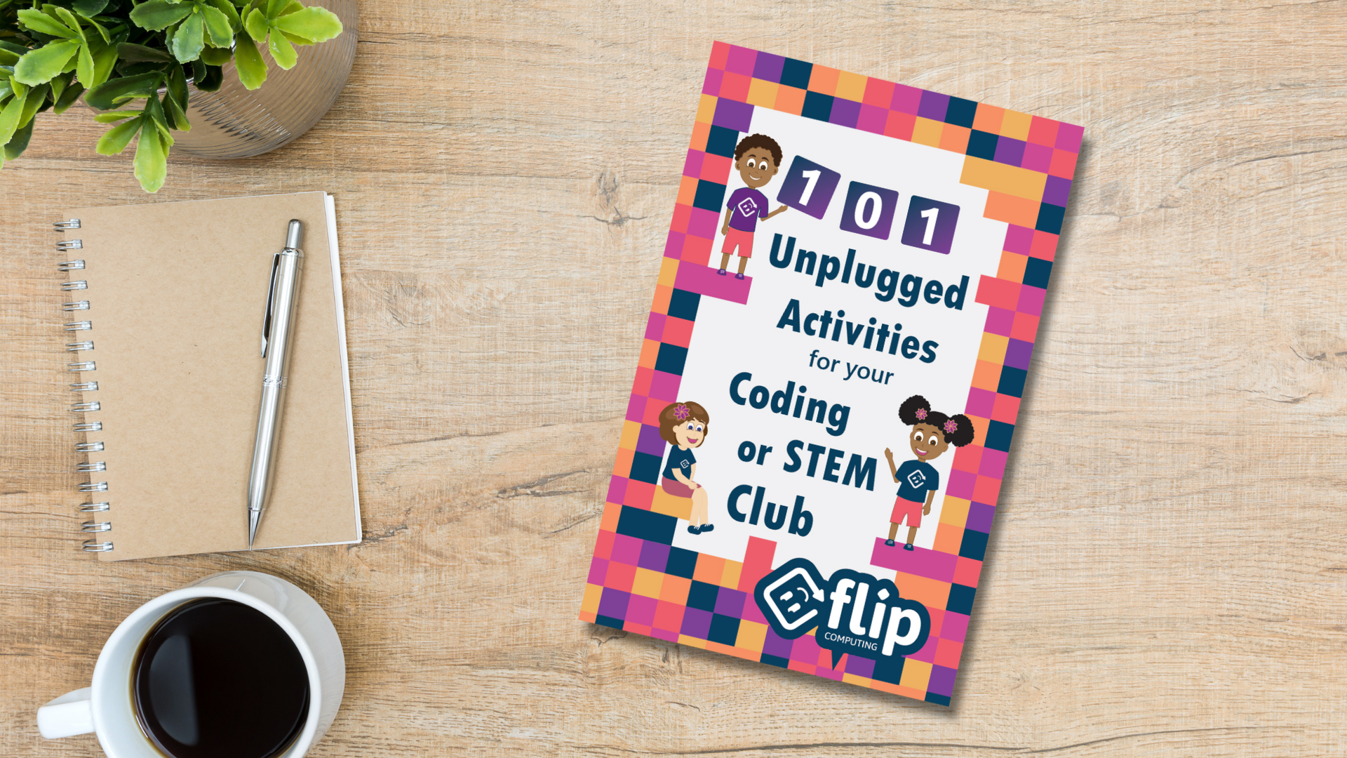 A copy of the book '101 unplugged activities for your coding or STEM club' is placed on a table next to a cup of coffee.