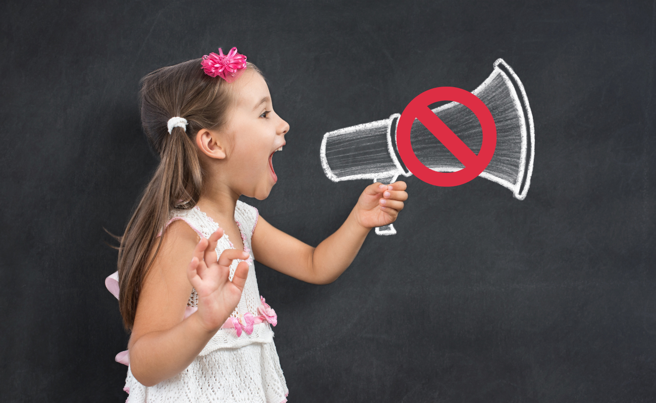 A child holding a megaphone with a no entry sign over it.