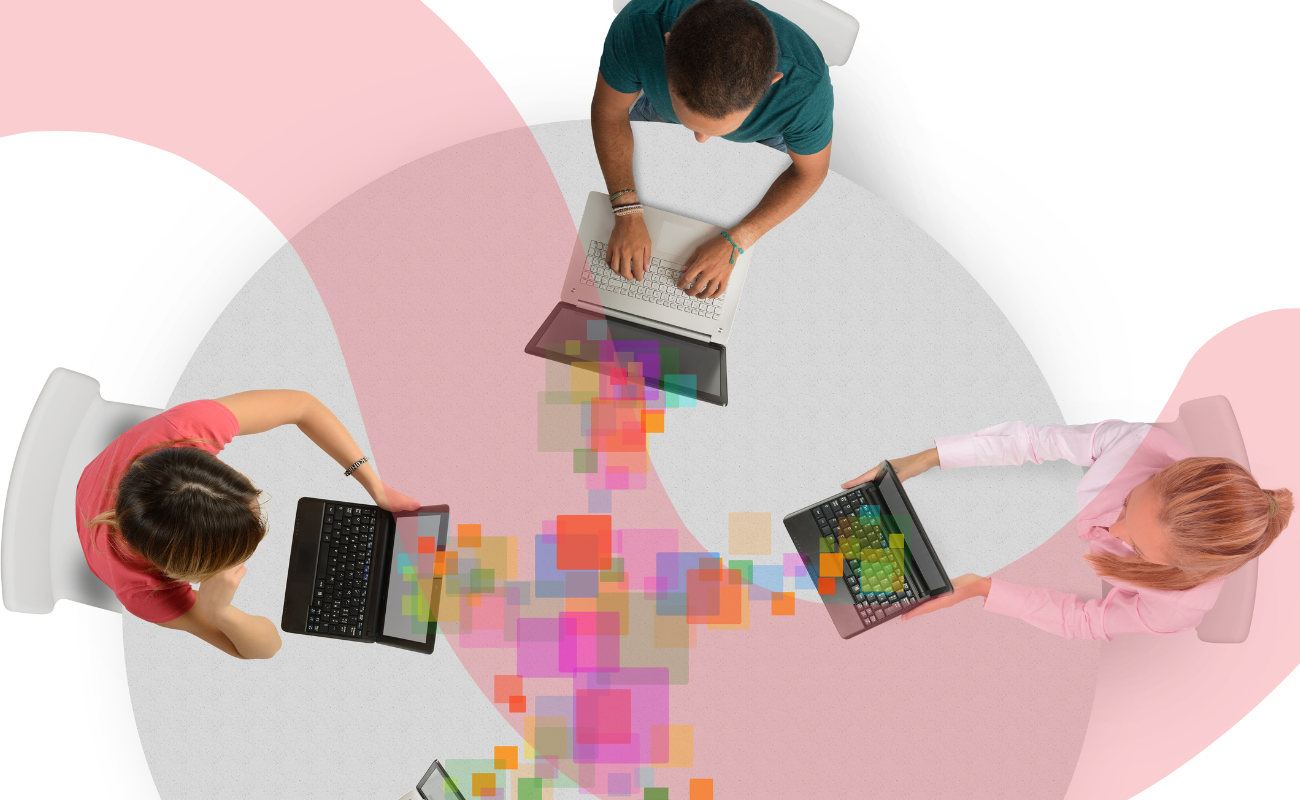 A graphic showing a top down view of three people at a circular table. They each have a laptop and a trail of multicoloured squares is coming from each laptop to meet in the middle of the table.